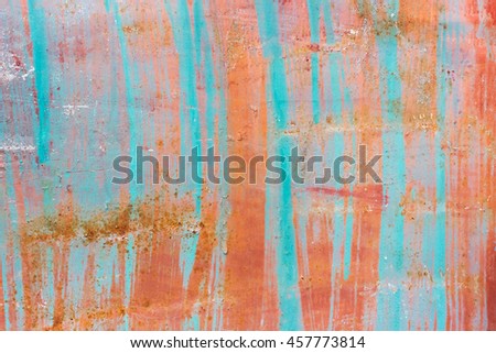 Rusted with stripes orange and blue painted metal wall. Texture
