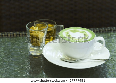 Hot green tea on a wooden table