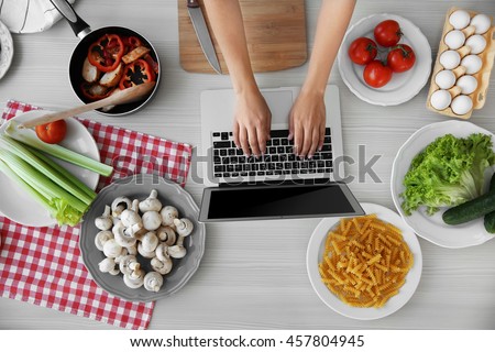 Woman cooking on kitchen. Food blog concept, top view Royalty-Free Stock Photo #457804945