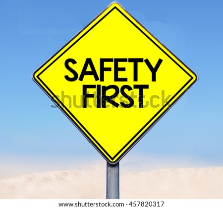 Word safety first on road sign on sky background