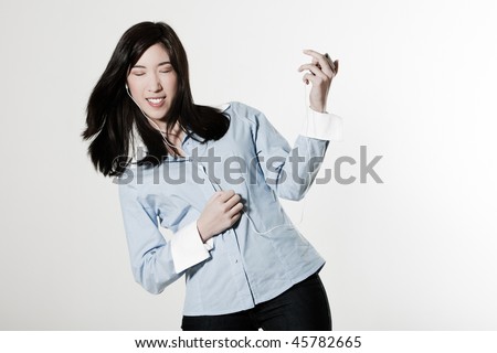 studio shot portrait of a beautiful southeast asian young woman playing air guita