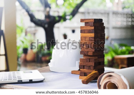 Planning, risk and strategy of project management in business, businessman and engineer gambling placing wooden block on a tower.Business and construction concept.