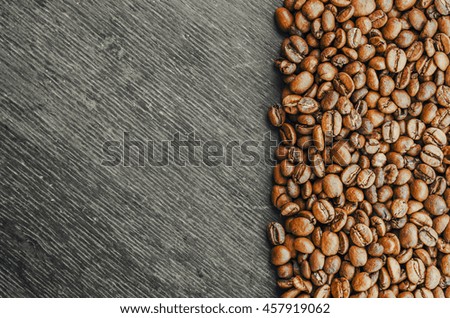 Roasted brown coffee beans, black wooden  background and texture, business card mock up background and texture,