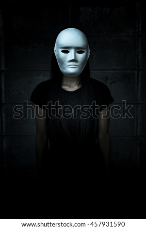 Mysterious woman in black dress wearing white mask,Scary background for book cover