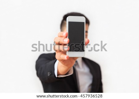 A professional businessman showing information in smart mobile to support  presentation