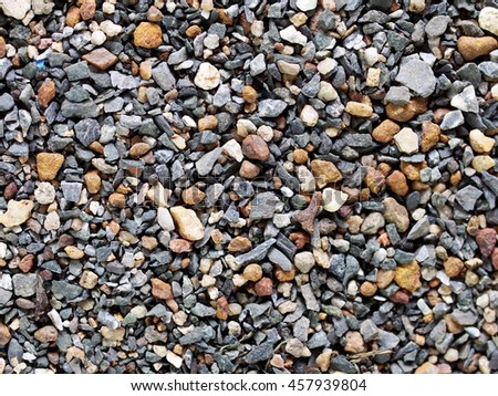 small river stone mixed from variety colours shape and forms on pathway ground floor as texture background picture
