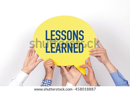 Group of people holding the LESSONS LEARNED written speech bubble Royalty-Free Stock Photo #458018887