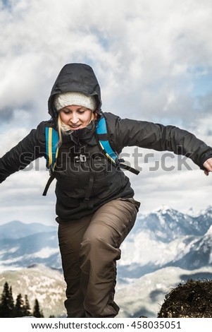 Young woman hiking in mountains, Hundsarschjoch, Vils, Bavaria, Germany