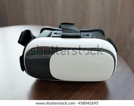 virtual reality glasses on wooden table blurred background.