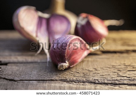 Purple Garlic on the grunge vintage board at a village kitchen - food photography