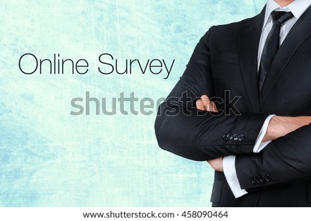 A businessman with his arms crossed near text - online survey