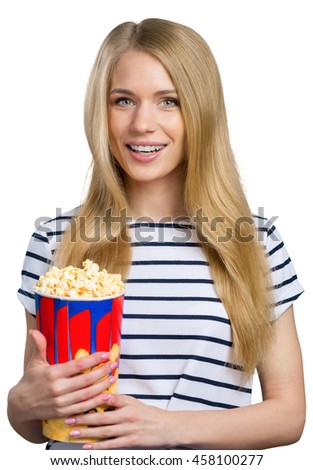 Beautiful girl eating popcorn on white background