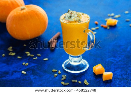 Pumpkin spice orange smoothie on a blue background