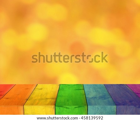table from multicolored wooden boards with blurred light background