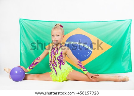 Girl doing rhythmic gymnastics element use ball, split. Compete in individual events. Brazilian flag at the white background. Brazil fan support. Gymnastics program