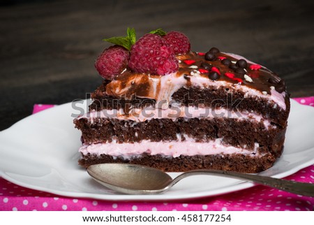Chocolate cake with fresh berries. Biscuit with pink strawberry cream. Selective focus.