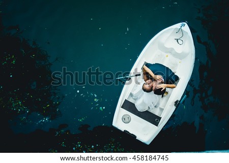 lovely man  kissing his amazing  wife   in a boat