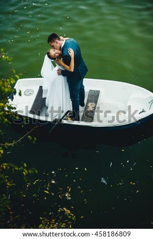 amazing man  kissing his wife   in a boat