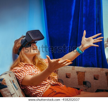 Virtual reality glasses. VR helmet. square photo of young charming girl smiling in virtual reality helmet