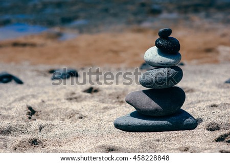 Stones balance on vintage beach, inspirational summer landscape. Spa or well-being, freedom and the concept of stability on the rocks.
