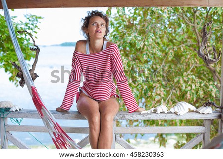 Photo young girl relaxing on beach in Bungalow. Smiling woman spending chill time outdoor summer. Caribbean Ocean Vacations. Horizontal, blurred background