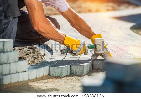 Garden Brick Pathway Paving by Professional Paver Worker. Royalty-Free Stock Photo #458236126