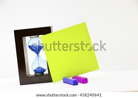 Blank note with sand clock for writing message on white background