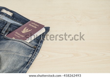 Passport and old jeans on the table.