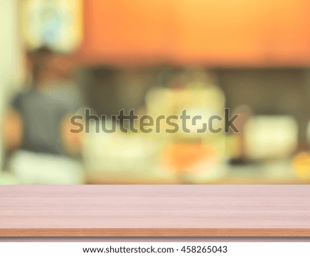 wood kitchen table top with blur kitchen background. used for display product.