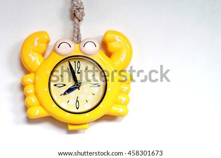 Colorful crab wall clock on clear background with sunlight, Image with space for text or other design (Copy space).