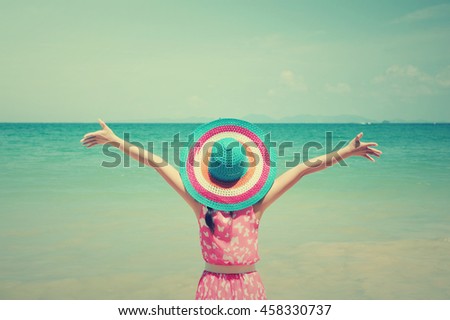 Happy  Woman standing on the beach and blue sky.Summer holiday concept.Vintage Tone