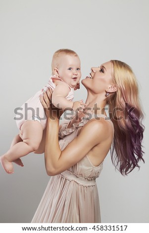 happy loving Mother and Baby. Happy Family. young mother woman with pink hair