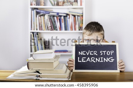 Never Stop Learning. Boy holding blackboard