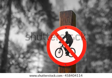 Road sign circular shape with a picture of the No Cycling on a black and white background of summer forest