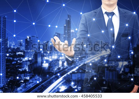 Double exposure of professional businessman and network connection with blurred cityscape in communication , technology and business concept