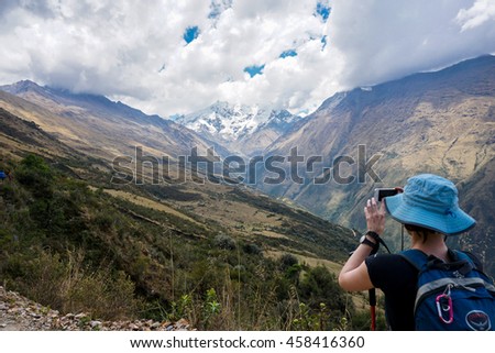 A girl taking a photo during her Salkantay Mountain Hike, Peru