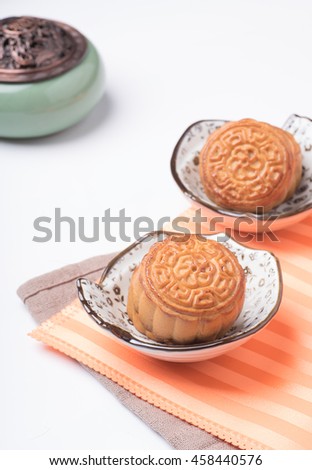 Traditional mooncakes on blank background  with teacup and tea