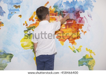 Child, student, boy on the background of the world map