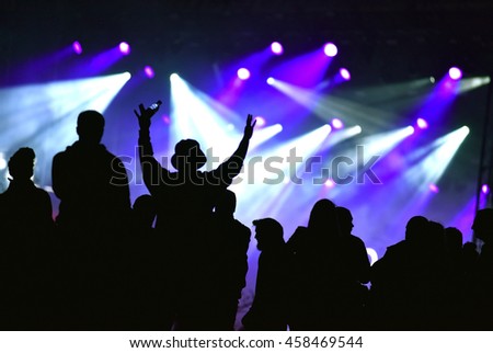 Stage lights. Concert scene with crowd in the foreground