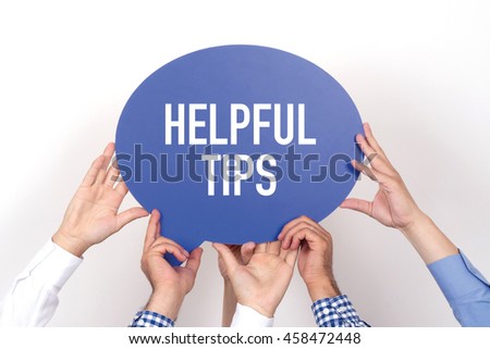 Group of people holding the HELPFUL TIPS written speech bubble