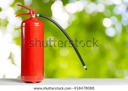 Red fire extinguisher on a wooden table