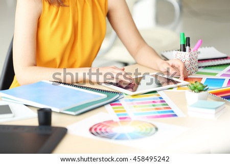Designer workplace. Woman using tablet