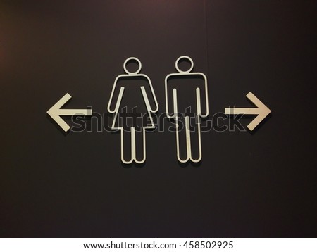 Sign of public restroom on black background