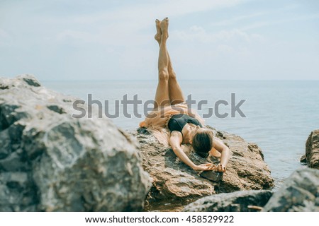 Girl on the shore on the rocks