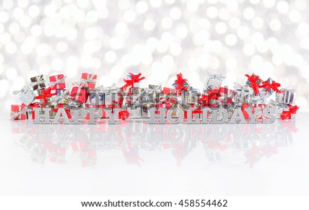 Happy holidays silver text on the background of gifts on a bokeh background