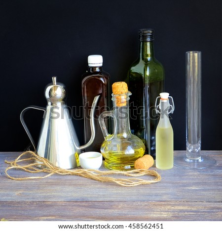 Random collection of kitchen bottles and jugs with oil, vinegar, wine etc. used for cooking and dressing, Special light.