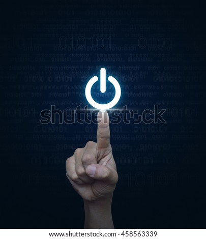 Hand pressing power button over computer binary code blue background Royalty-Free Stock Photo #458563339