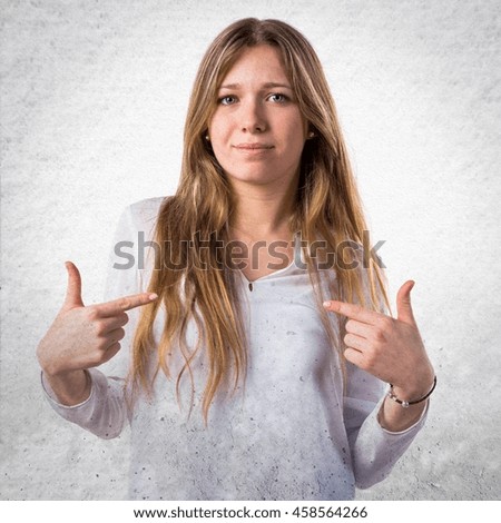 Teen girl doing surprise gesture over textured background