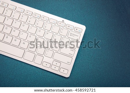 Computer keyboard on dark blue background. High resolution.