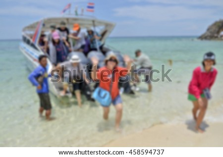 Blur picture of tourist embark a speed boat at an island